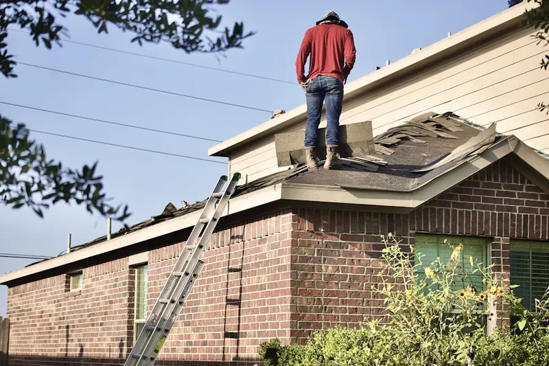 Professional roofer working on a residential roof in Allendale-Lakeside